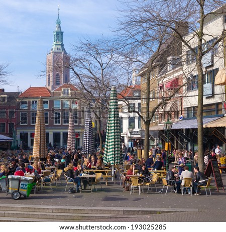 THE HAGUE - MARCH 14, 2014: Unknown people enjoying the nice weather on terraces in the center of The Hague. The Hague is the third city in the Netherlands with over 500,000 residents