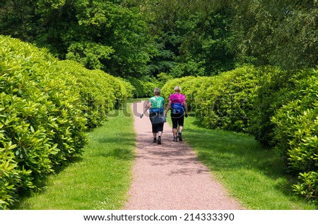 OLDENZAAL, NETHERLANDS - JUNE 1, 2014: Two unknown elderly women hiking in a park.  In the Netherlands are in 2014 more than 2.9 million people over 65 (17.3% of the population).