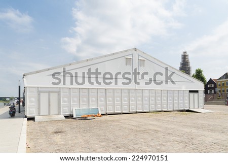 large white event tent under a sunny sky