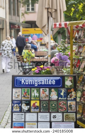 DUSSELDORF, GERMANY - SEPTEMBER 6, 2014: Konigsallee street name sign. The street is famous for the fashion showrooms and luxury retail stores located along its sides.