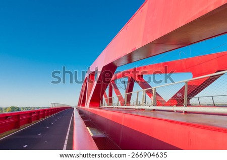 bicycle lane along the new red railroad bridge over the IJssel river in the Netherlands