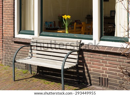 small bench in front of a window