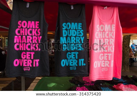AMSTERDAM - AUGUST 2, 2015: Sale of t-shirts during the Amsterdam Gay Pride, a festive event with a gay cultural character. It is held annually since 1996 during the first weekend of August.
