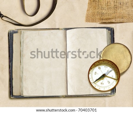 ancient logbook and compass on faded paper, copyspace