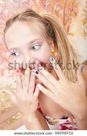 smiling beautiful caucasian girl  with hands which has color nails