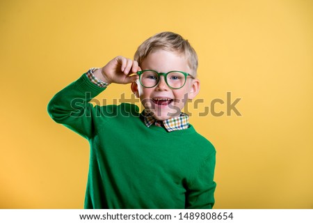 Similar – Image, Stock Photo Little blonde sweet girl is noodles with tomato sauce and smears her face with red sauce with her hand, she holds the small spoon in her hand, over a bowl and looks curiously into the camera, at home in the apartment.