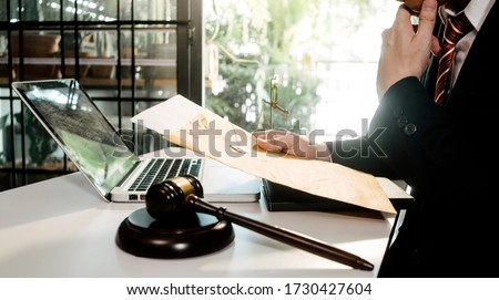 Business and lawyers discussing contract papers with brass scale on desk in office. Law, legal services, advice, justice and law concept  picture with film grain effect ストックフォト © 