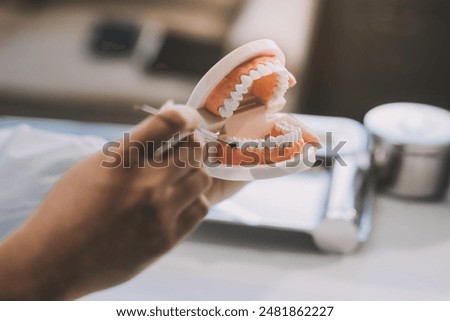 Similar – Image, Stock Photo Dentist working with denture in laboratory