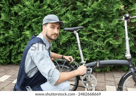 Similar – Image, Stock Photo Repairman fixing bicycle wheel in workshop
