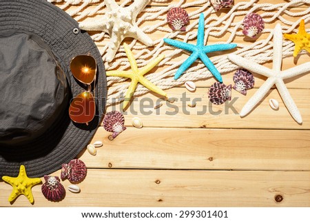 fisherman hat and fishing net on the wooden board