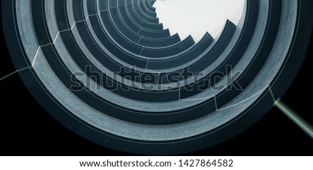 Reworked underside view of curvilinear balconies. Modern architecture seen from low angle. Hi-rise building exterior. Modular architectural structure of multistory house. Round geometric composition.