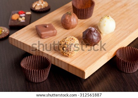 Chocolate handmade candies on a kitchen table, horizontal