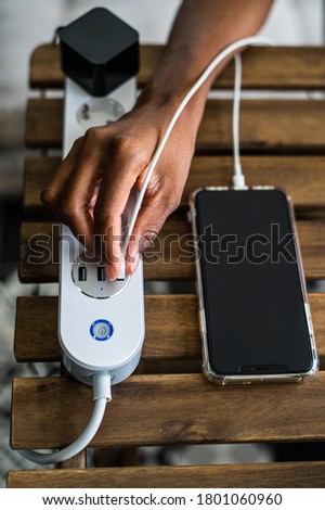 Similar – Image, Stock Photo Crop ethnic person recharging device