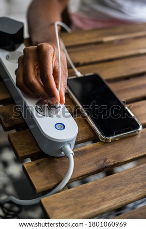 Similar – Image, Stock Photo Crop ethnic person recharging device