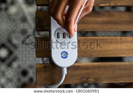 Similar – Image, Stock Photo Crop ethnic person recharging device