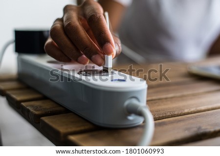 Similar – Image, Stock Photo Crop ethnic person recharging device