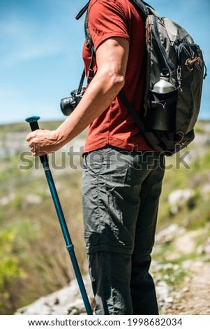 Similar – Image, Stock Photo Unrecognizable hiker observing wild valley from rocky cliff