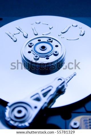 Closeup of the platters and read/write head of a computer hard drive