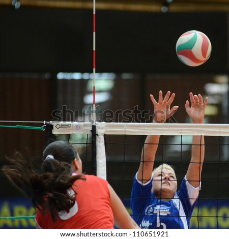 KAPOSVAR, HUNGARY - APRIL 22: Zsofia Horvath (blue 5) in action at the Hungarian I. League volleyball game Kaposvar (blue) vs Budai XI. SE (red), April 22, 2012  in Kaposvar, Hungary.