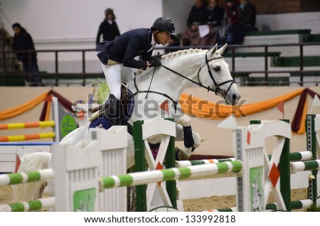 KAPOSVAR, HUNGARY - MARCH 24: Balazs Horvath jumps with his horse (Frederik) on the Masters Tournament International Jumping Competition, March 24, 2013 in Kaposvar, Hungary