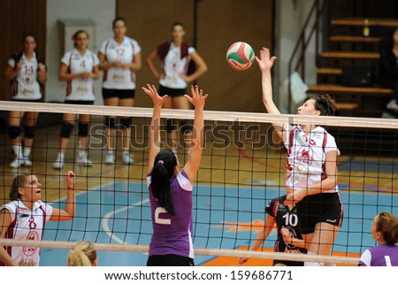 KAPOSVAR, HUNGARY - SEPTEMBER 20: Krisztina Stirt (white 15) in action at the Hungarian I. League volleyball game Kaposvar (white) vs Ujpest (purple), September 20, 2013 in Kaposvar, Hungary.