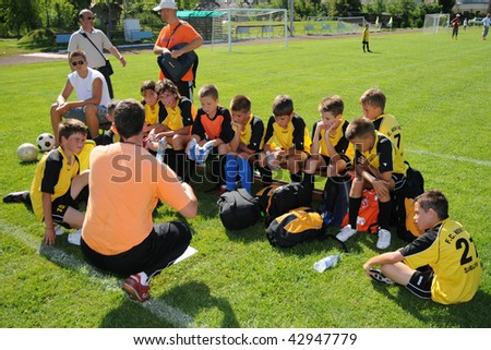 KAPOSVAR, HUNGARY - JULY 20: Unidentified players listen to their trainer at the V. Youth Football Festival match - July 20, 2009 in Kaposvar, Hungary.