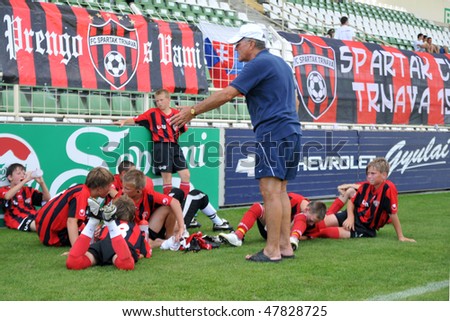 KAPOSVAR, HUNGARY - JULY 22: Unidentified players listen to their trainer at the V. Youth Football Festival match FC Furth (AUT) vs. Spartak Trnava (SVK) - July 22, 2009 in Kaposvar, Hungary