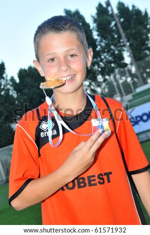 KAPOSVAR, HUNGARY - JULY 24: Novi Grad player show his medal the win after the VI. Youth Football Festival Under 12 Final FK Novi Grad (BOS) vs. FK 7 Tuzla (BOS) July 24, 2010 in Kaposvar, Hungary