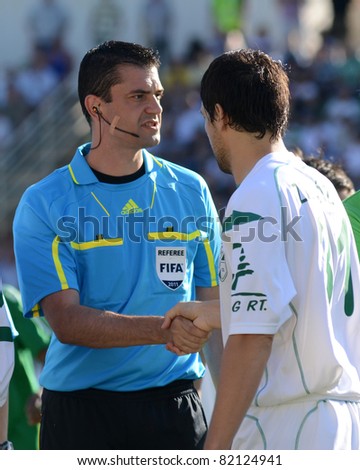 KAPOSVAR, HUNGARY - JULY 17: Viktor Kassai (L) (FIFA referee) before a Hungarian National Championship soccer game - Kaposvar (white) vs Ferencvaros (green) on July 17, 2011 in Kaposvar, Hungary.