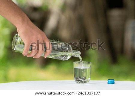 Similar – Foto Bild Mann füllt Glas mit Wein im Tal