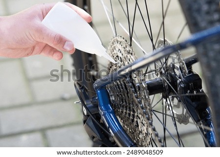 Similar – Image, Stock Photo Technician oiling bike chain in workshop