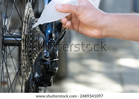 Similar – Image, Stock Photo Technician oiling bike chain in workshop