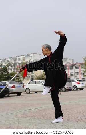 Luannan - September 20: an old man fencing in cultural activities square, the performance on September 20, 2014, the south of the luanhe river, hebei, China.