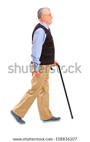 Full length portrait of a senior man walking with cane isolated on white background
