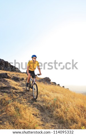 A view of a biker riding a mountain bike on a sunset, Macedonia