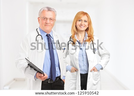 Male and female doctor standing in a hall of a clinic