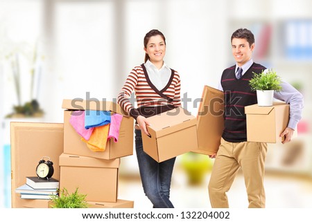 Young man and woman moving into an apartment
