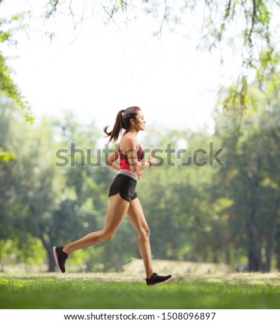 Similar – Image, Stock Photo Young brunette Woman running on asphalt road in summer park. Active sporty caucasian female has morning workout. Athletic person in sportswear exercises outdoor. Dressed leggings and sportive top