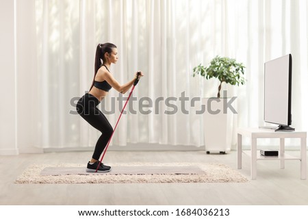 Similar – Image, Stock Photo Woman with resistance band on wrists working out at home