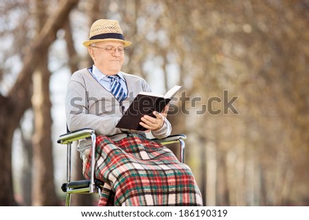 Senior man reading a book outside