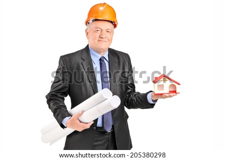 Mature architect holding plans and a small model house isolated on white background