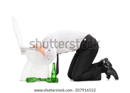 Drunk man throw up in a toilet with empty beer bottles next to him isolated on white background