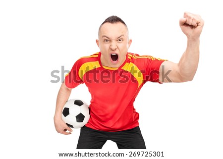 Ecstatic young sports fan in a red football jersey holding a football and cheering isolated on white background