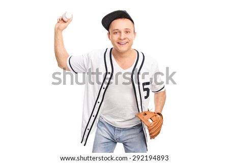 Cheerful young baseball player throwing a baseball and looking at the camera isolated on white background