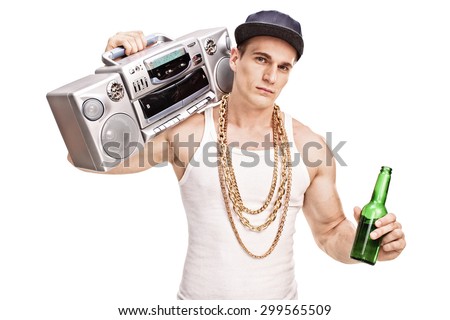 Young male rapper carrying a ghetto blaster over his shoulder and holding a bottle of beer isolated on white background
