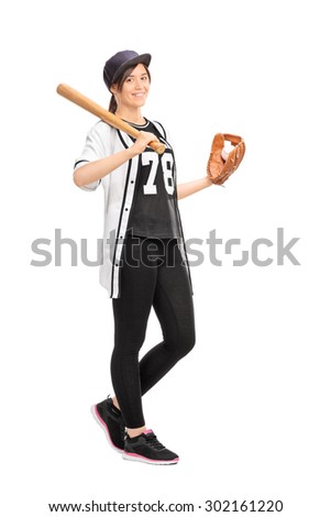Full length portrait of a young woman in a baseball jersey holding a baseball bat and smiling isolated on white background