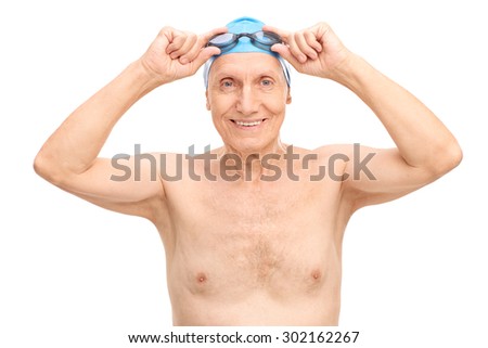 Cheerful senior with a blue swim cap putting on his swimming goggles and looking at the camera isolated on white background