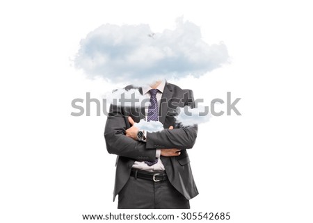 Studio shot of a businessman hidden behind a few small clouds isolated on white background