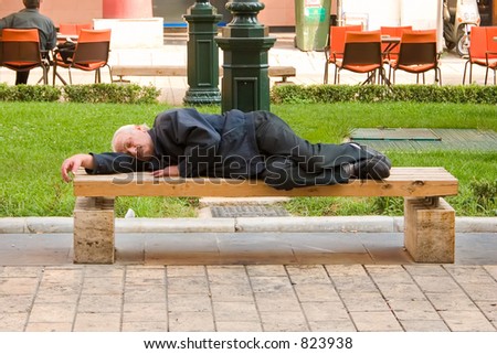 Homeless person sleeping on a bench