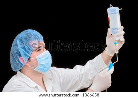 Ambulance worker examining infusion